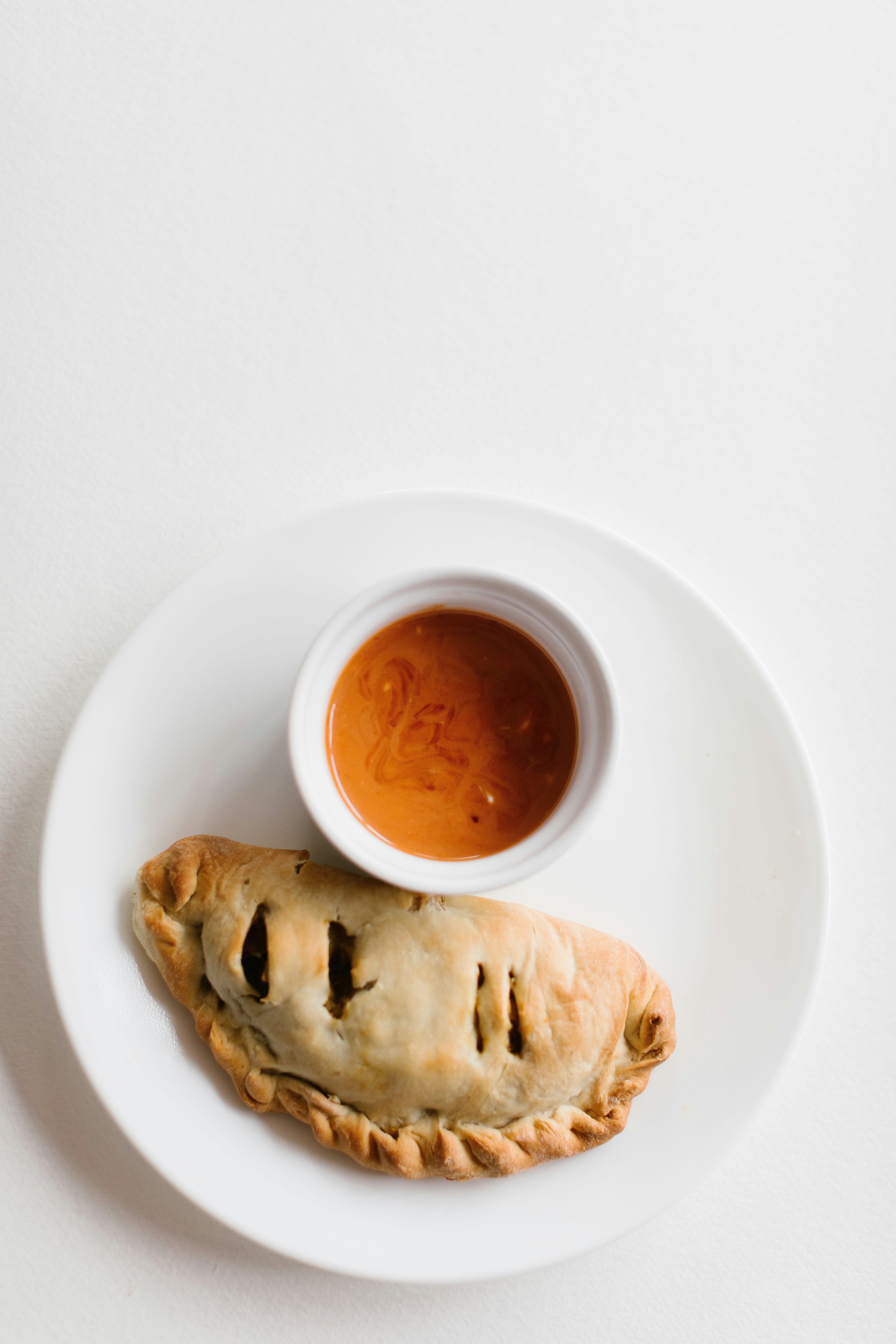 a plate with a pastry and sauce on it