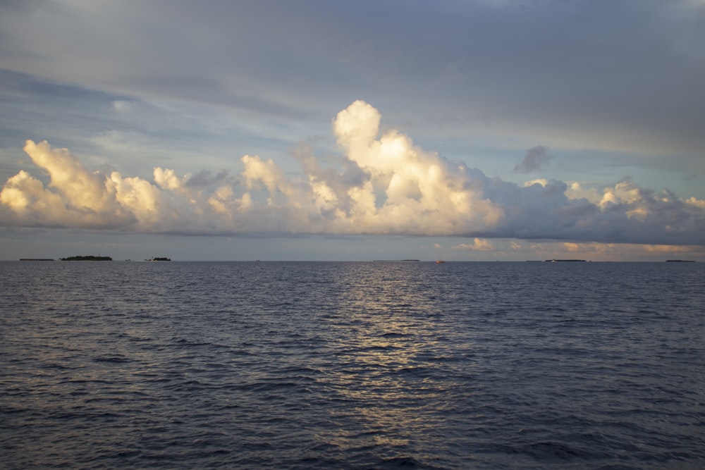 a large body of water under a cloudy sky