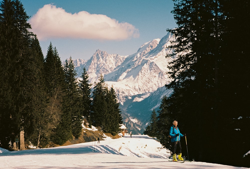 a man riding skis down a snow covered slope