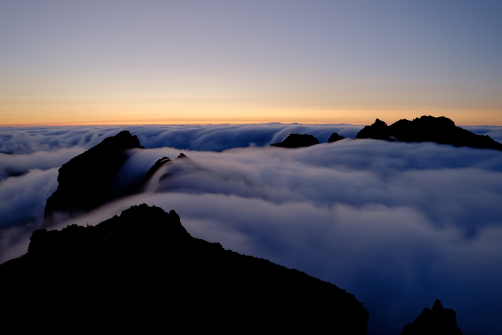 a view of a mountain covered in clouds