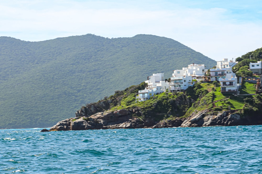 a small island with houses on it in the middle of the ocean