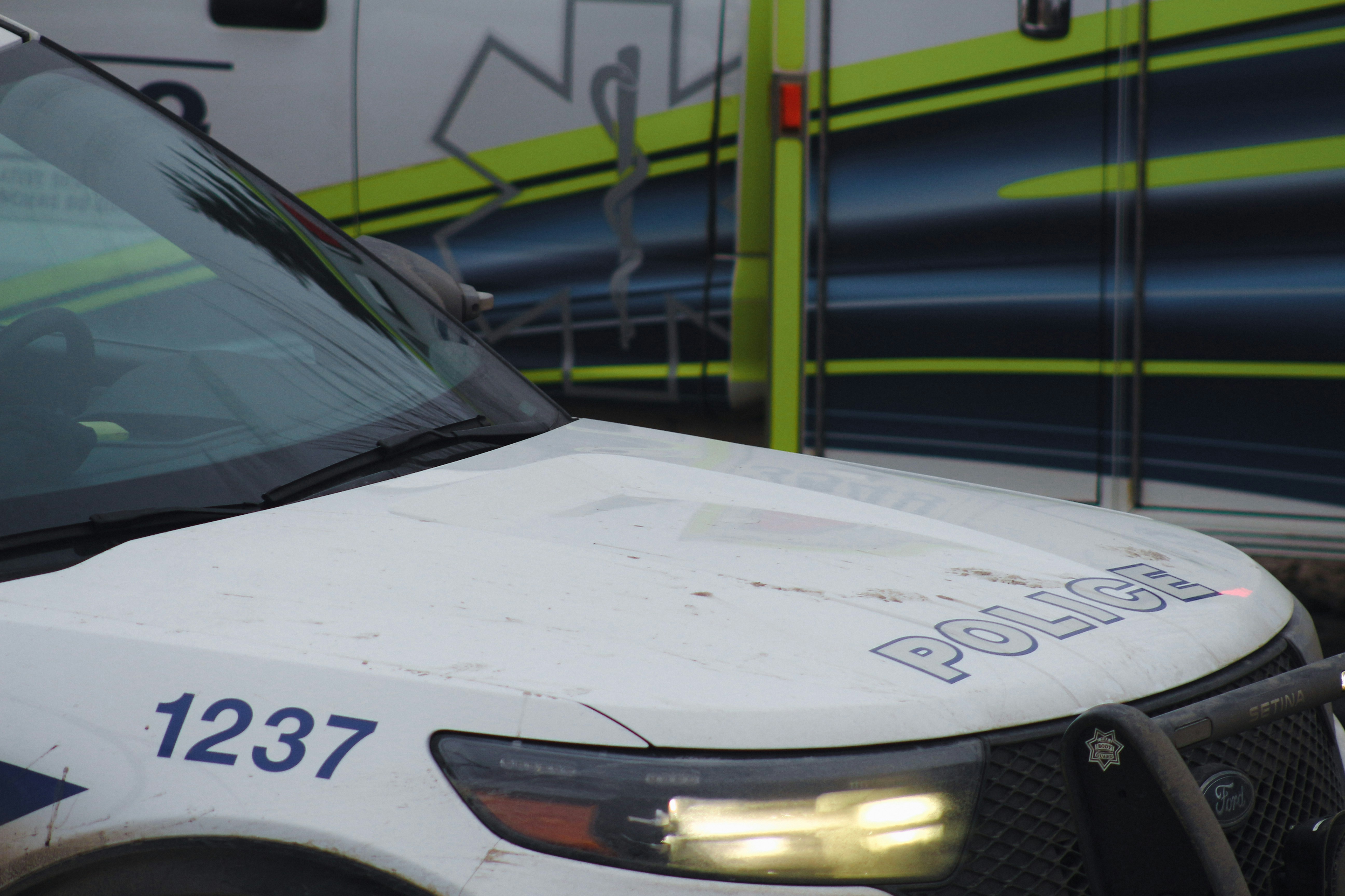 a police car parked in front of a bus