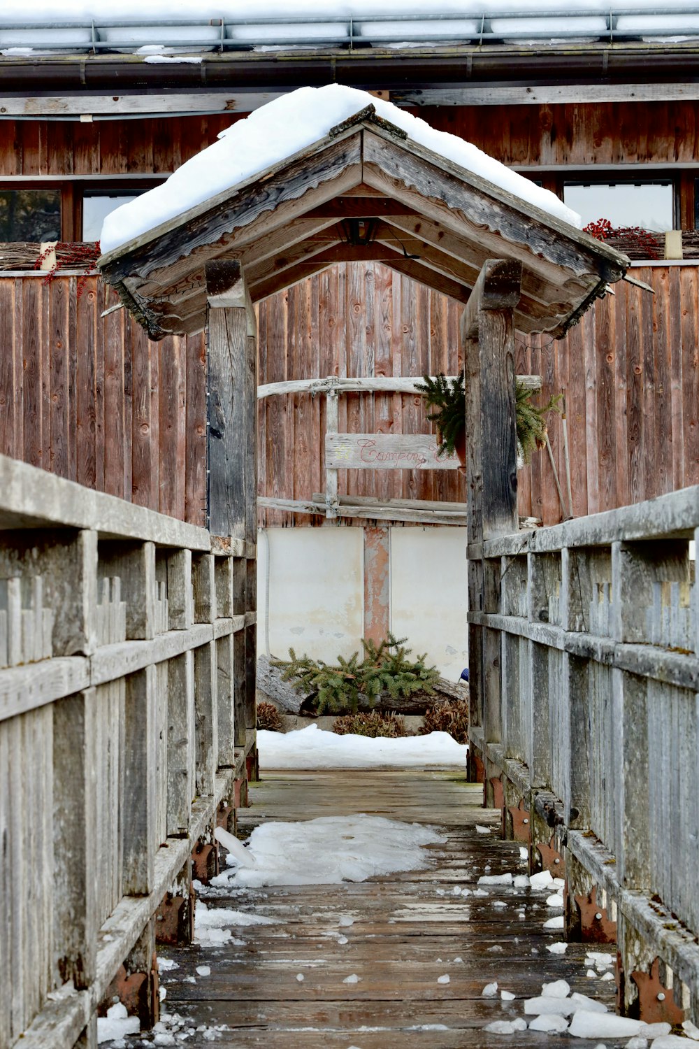 a small wooden structure with snow on the ground