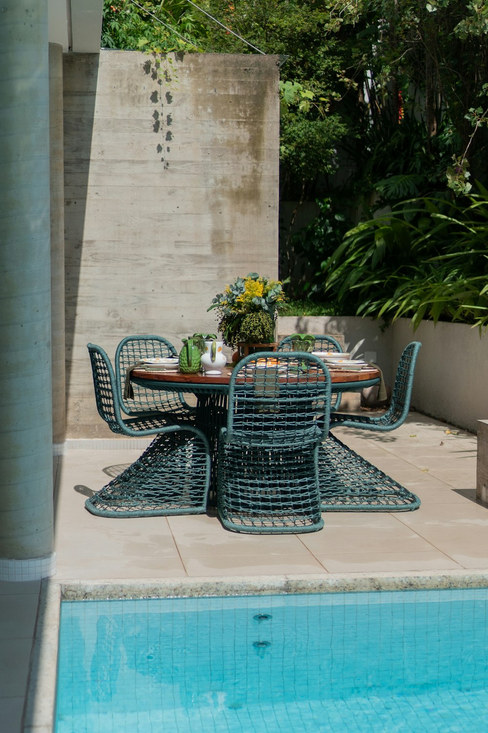 a table and chairs near a swimming pool