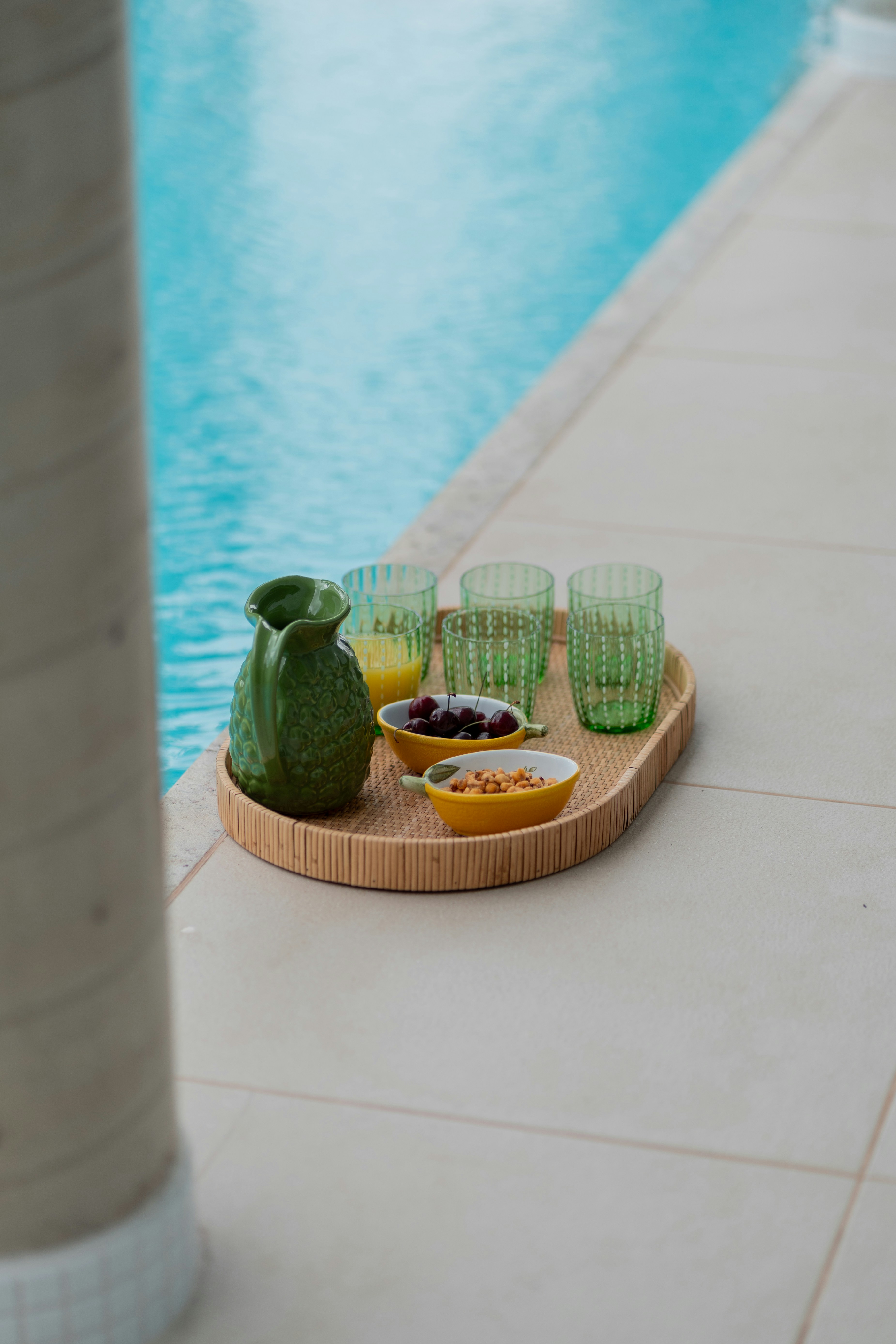 a tray of food next to a swimming pool