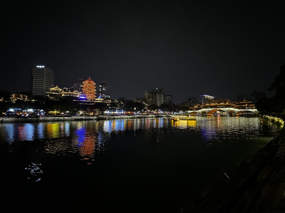 a body of water with a city in the background