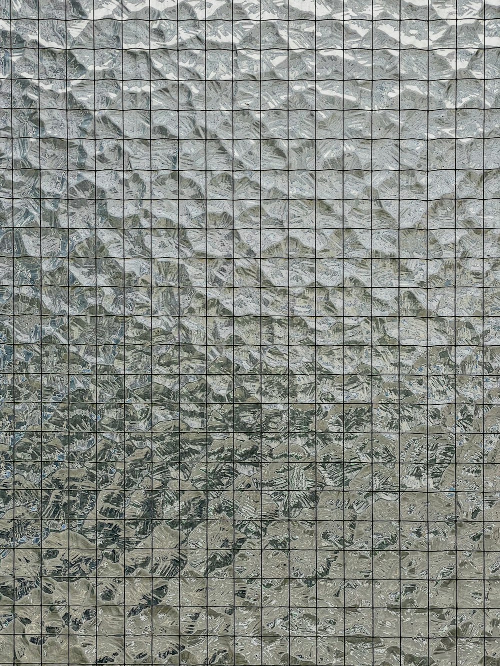 a close up of a glass window with mountains in the background