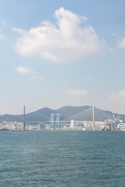 a large body of water with a city in the background