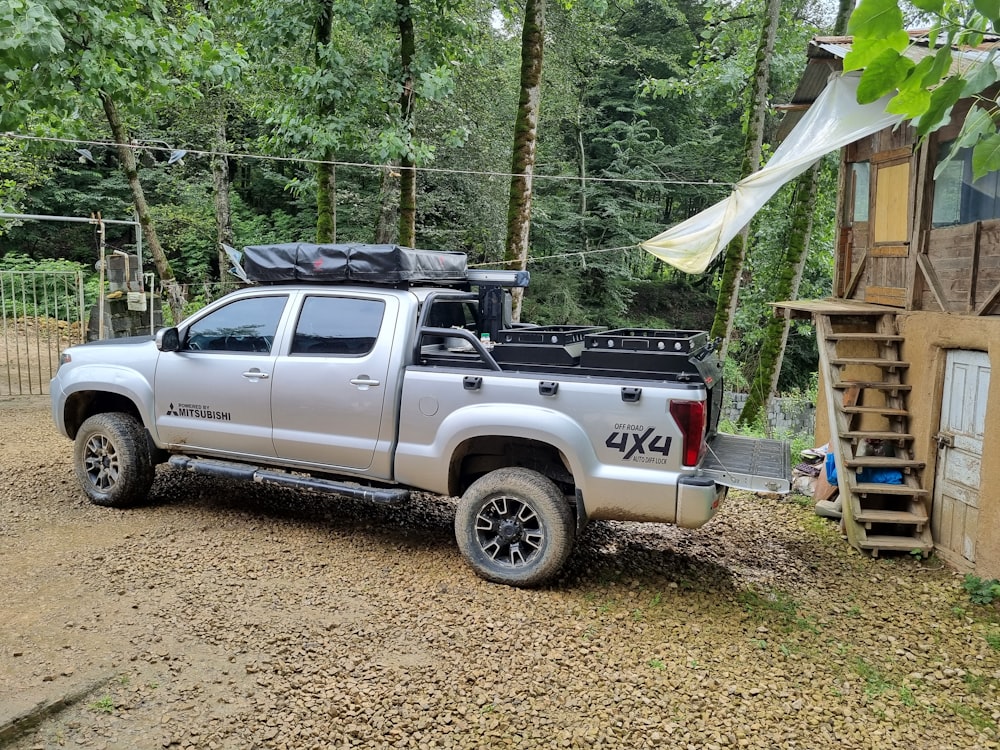 a silver truck with a camper on the back of it