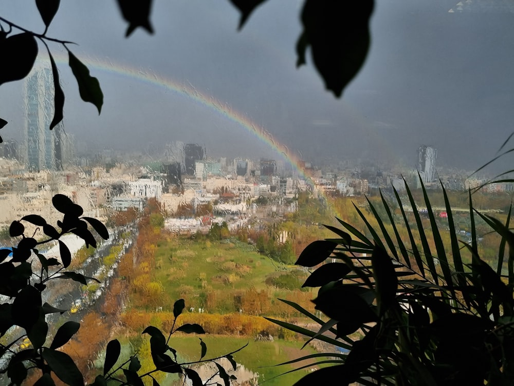a view of a city with a rainbow in the sky