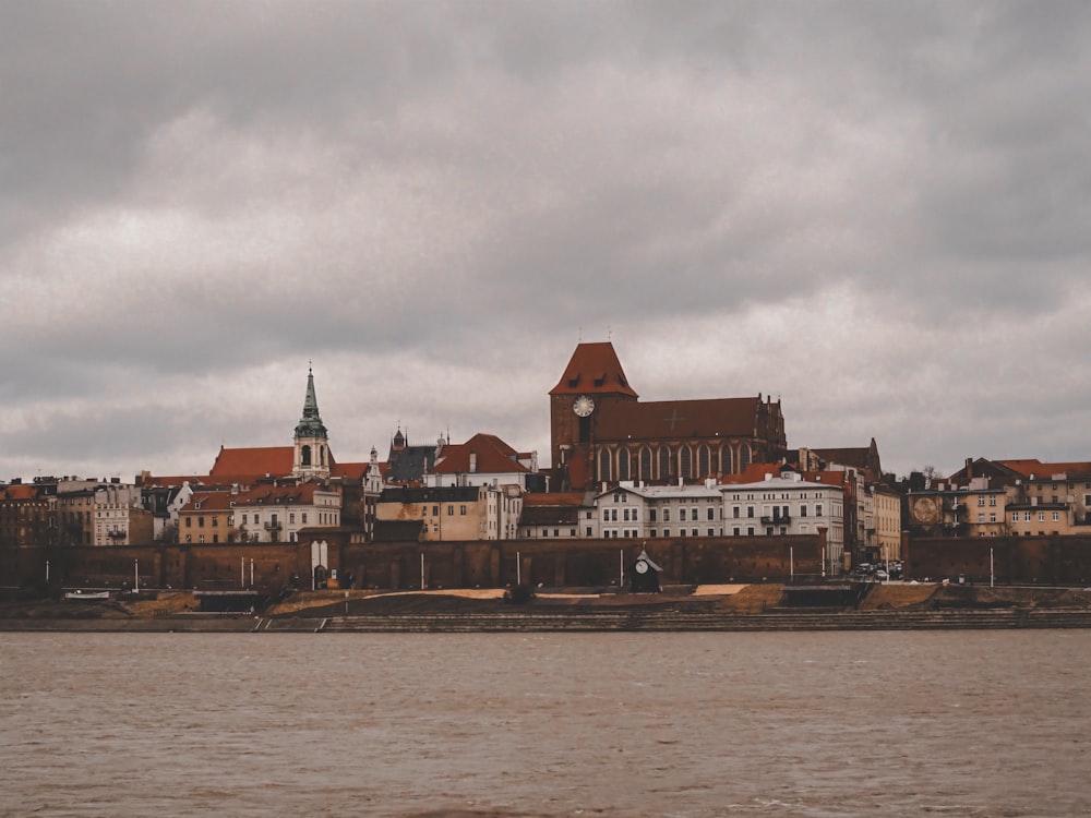 a large body of water with a city in the background