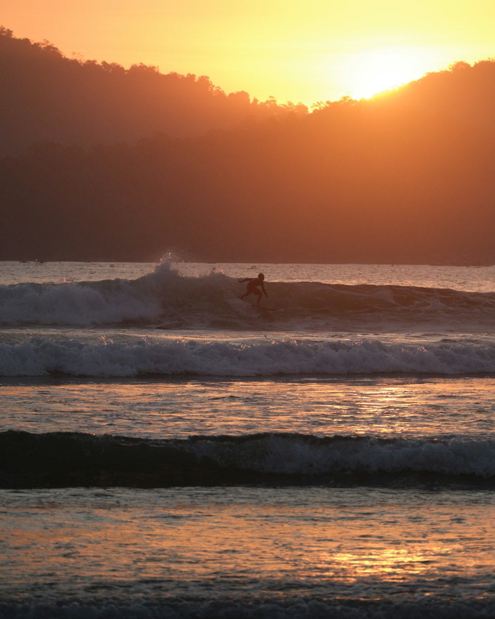 a person riding a wave on top of a surfboard