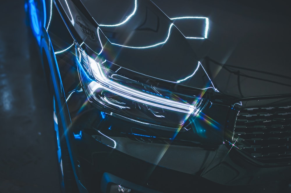 a close up of a car's headlight with a blurry background