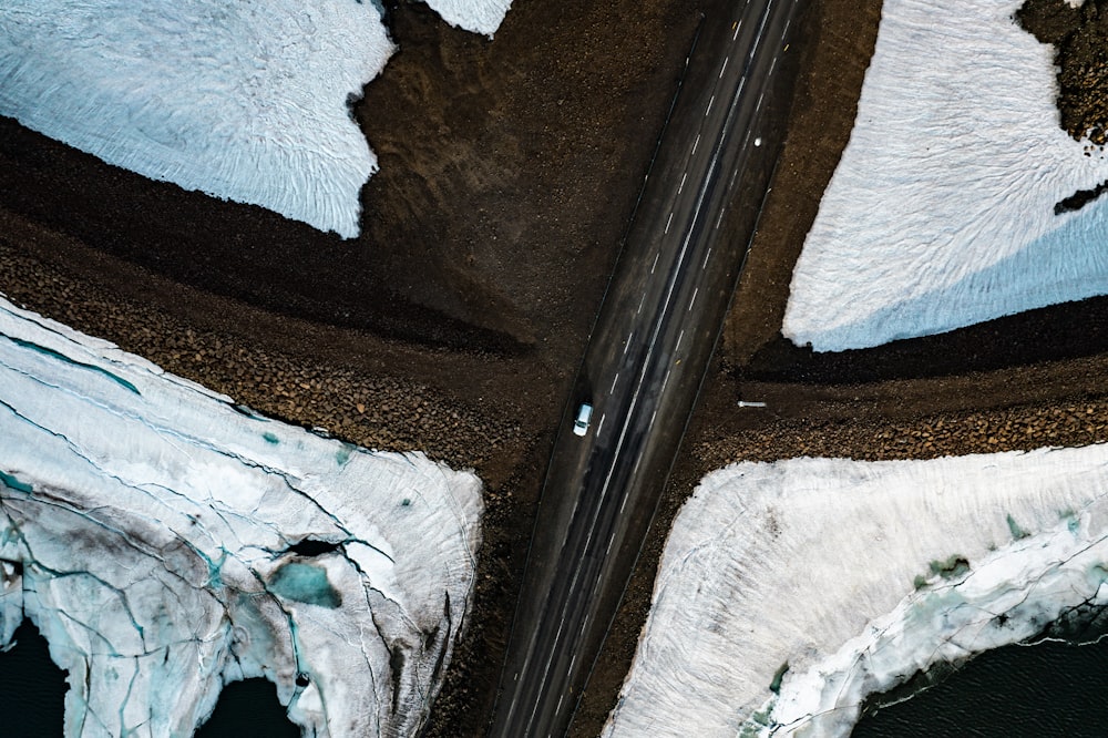 an aerial view of a road in the mountains