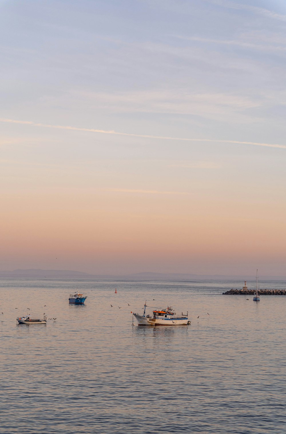 a group of boats floating on top of a large body of water