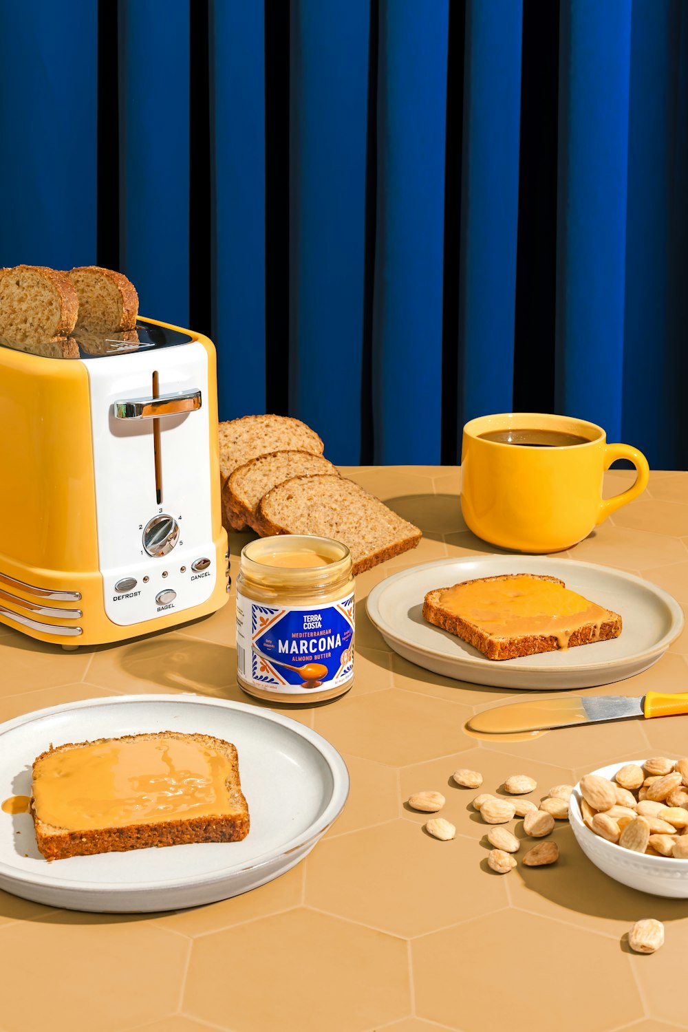 a table topped with plates of food and a toaster