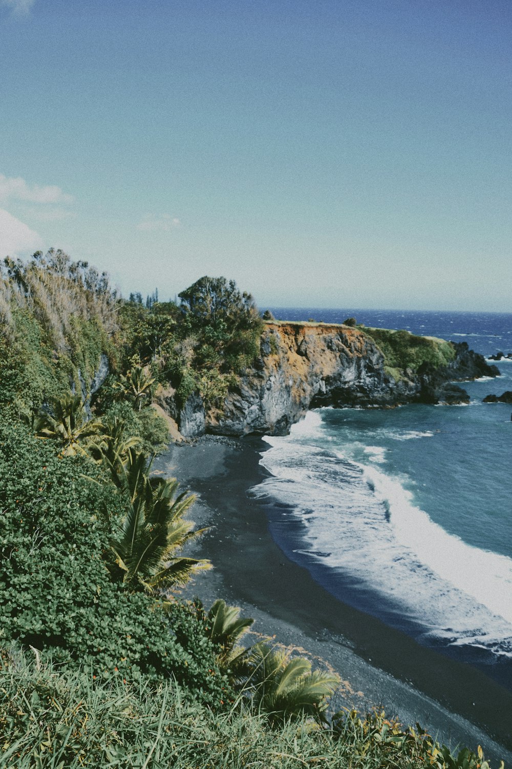 a view of the ocean from the top of a hill