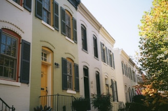 a row of houses with yellow doors and windows