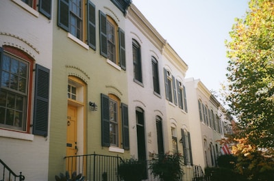 a row of houses with yellow doors and windows