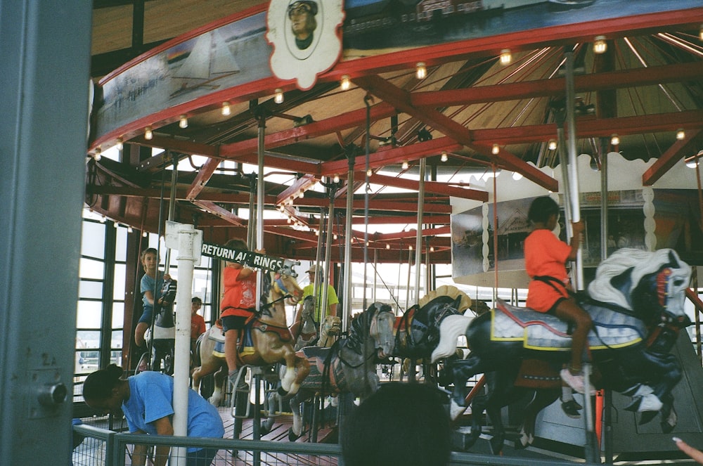 a group of people riding on top of a merry go round