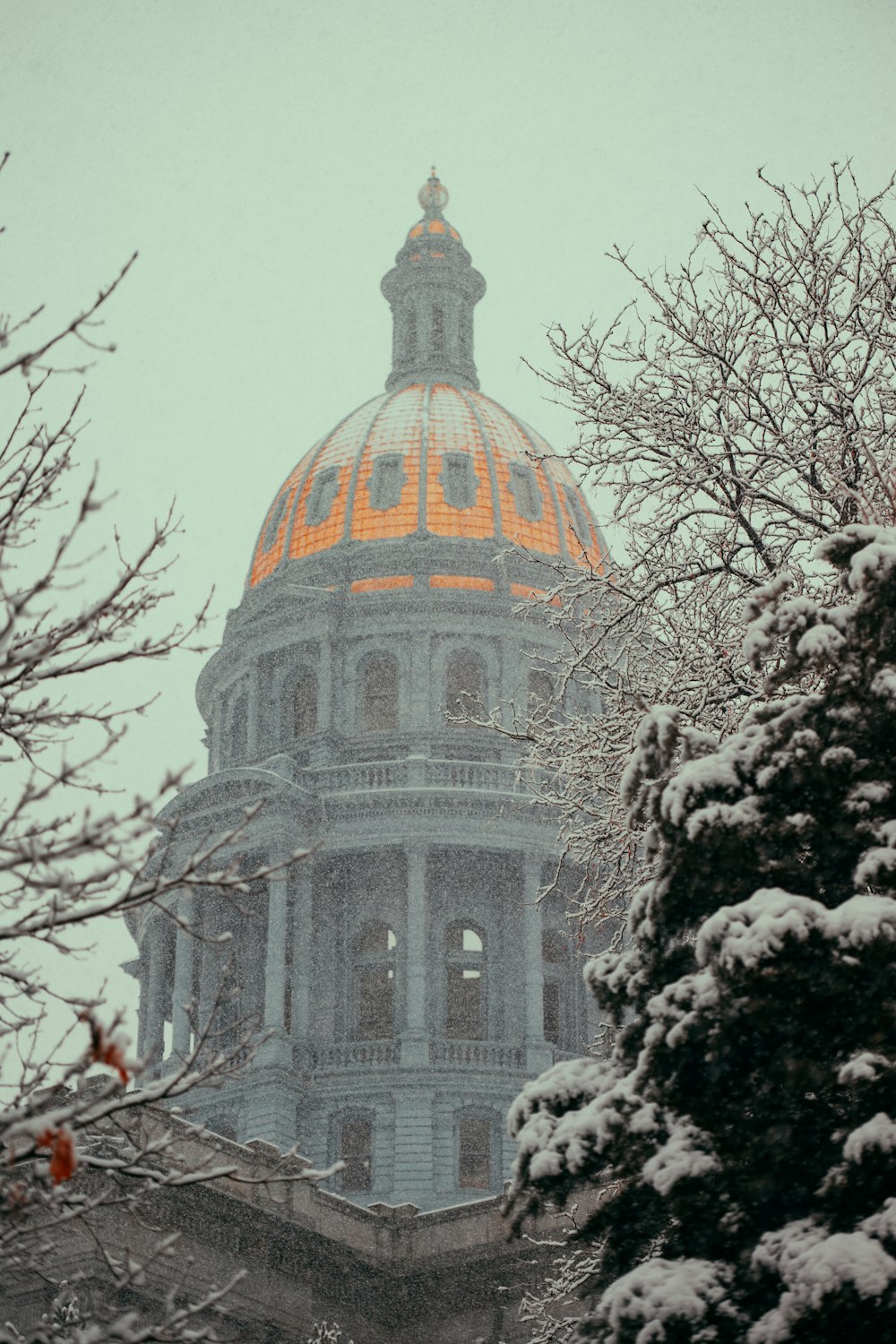 the dome of a building is covered in snow
