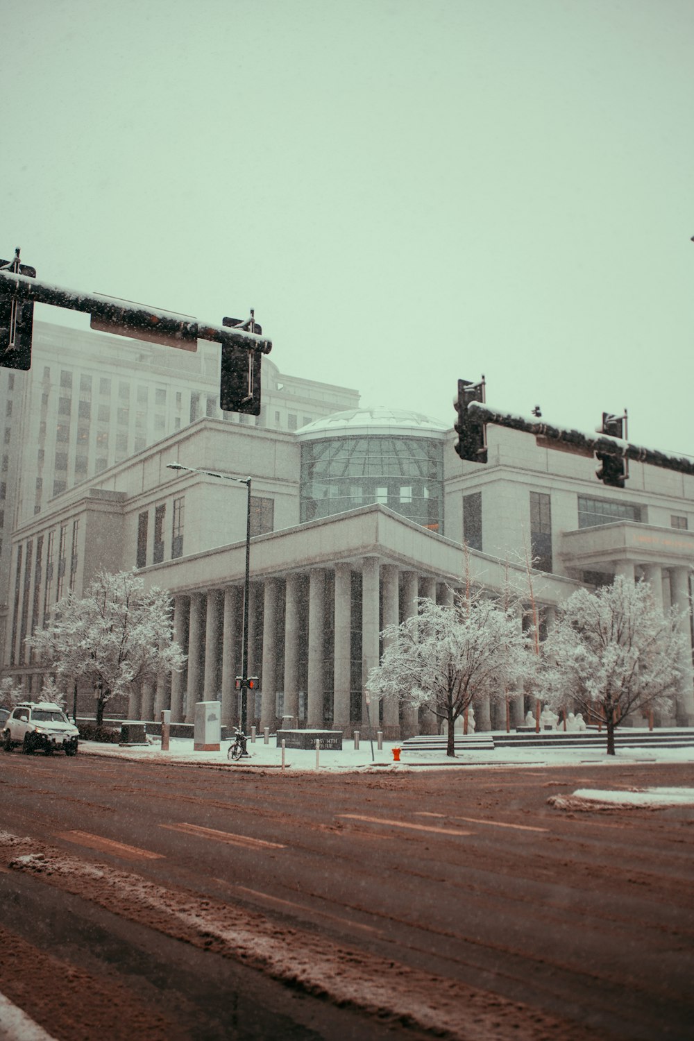 a snowy day in a city with a large building