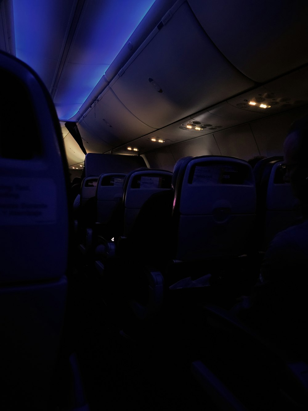 the inside of an airplane with blue lights