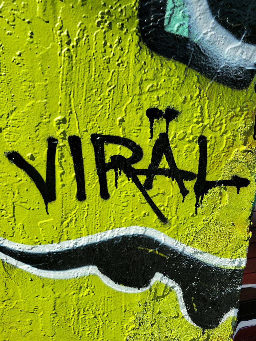 a close up of a wall with graffiti on it