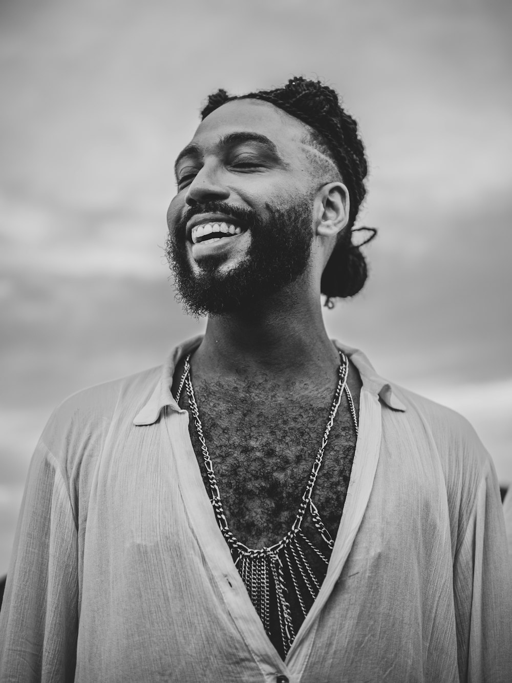 a black and white photo of a man smiling