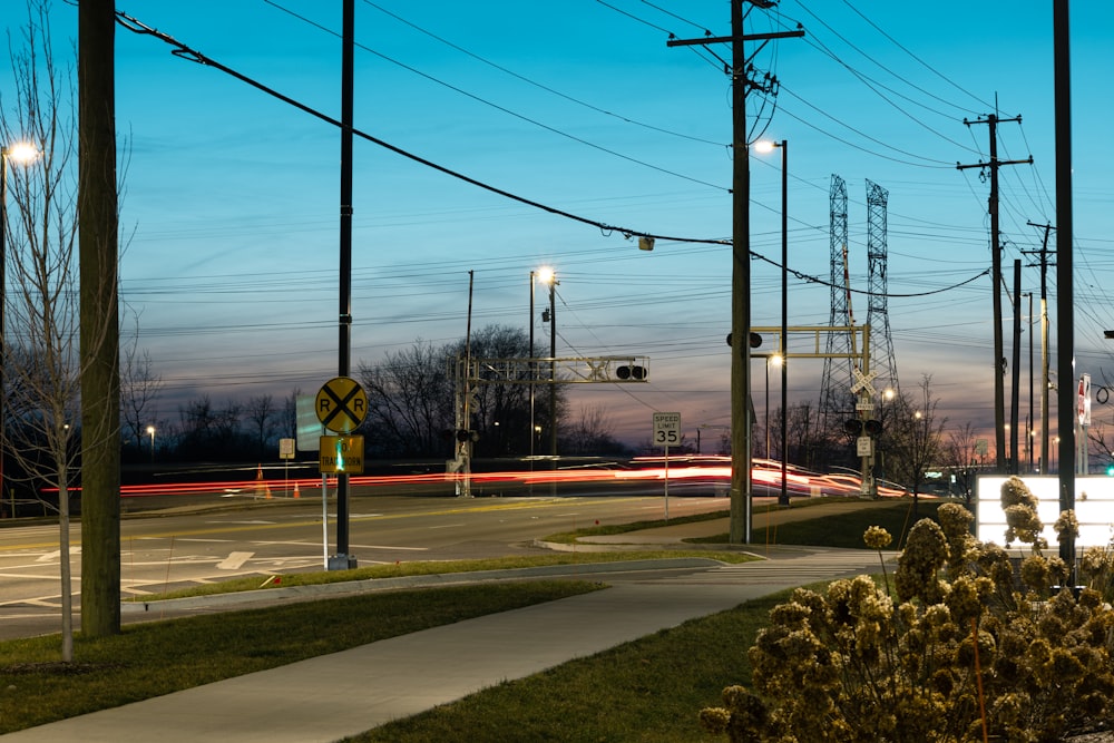 a city street at night with street lights and street signs