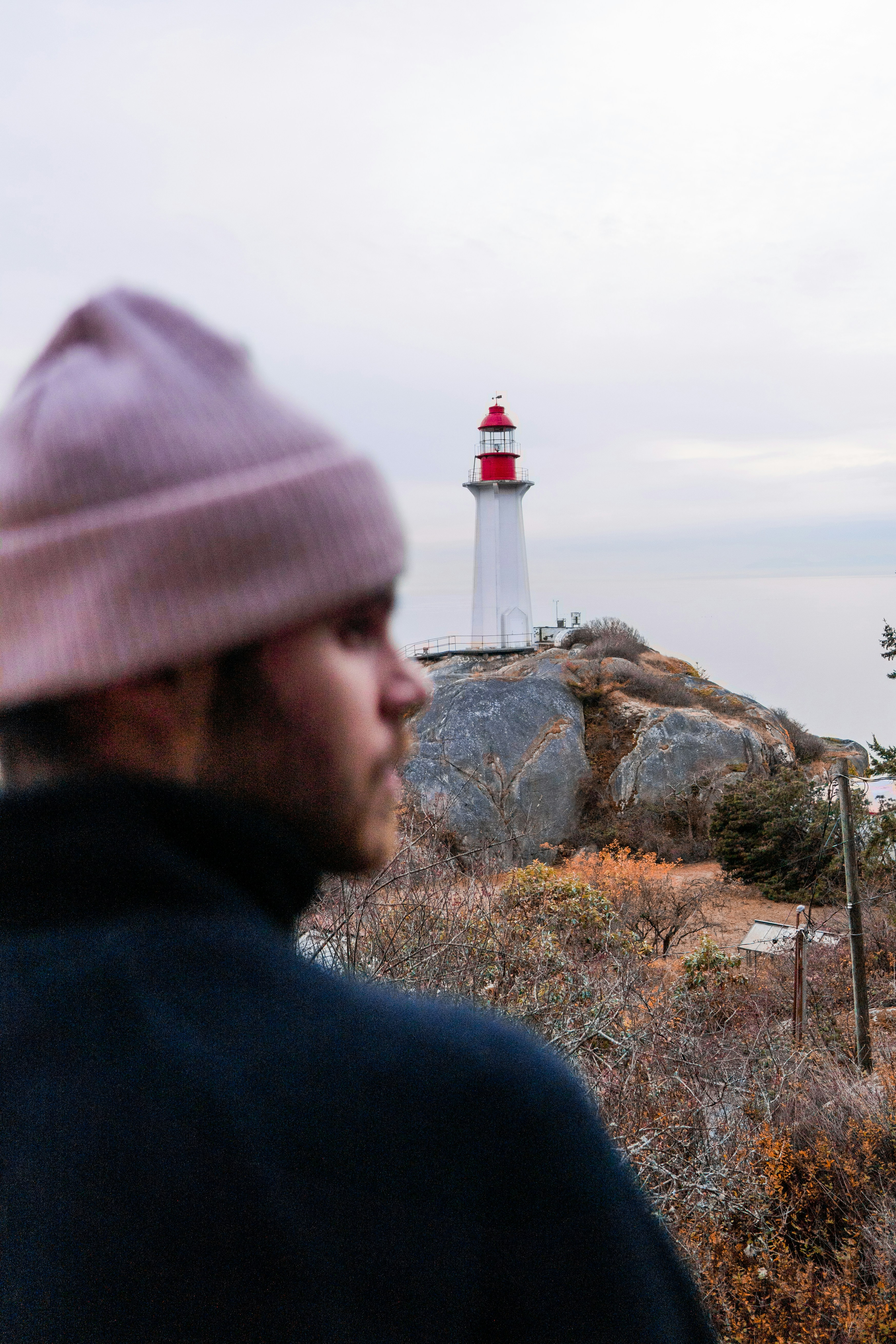 a man standing in front of a light house