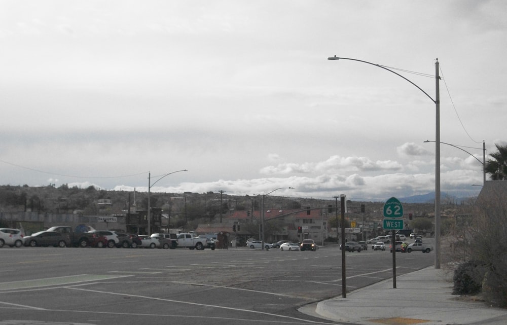 a city street with a lot of cars parked on the side of the road