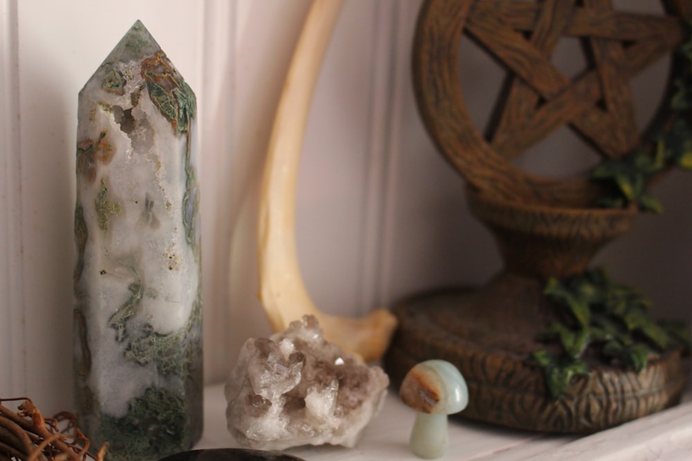 a couple of rocks sitting on top of a shelf