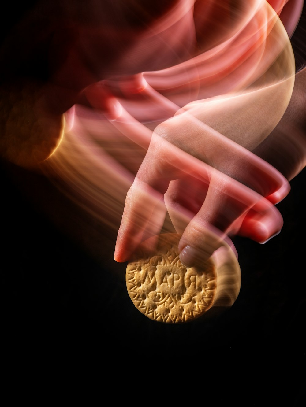 a close up of a person's hand holding a coin