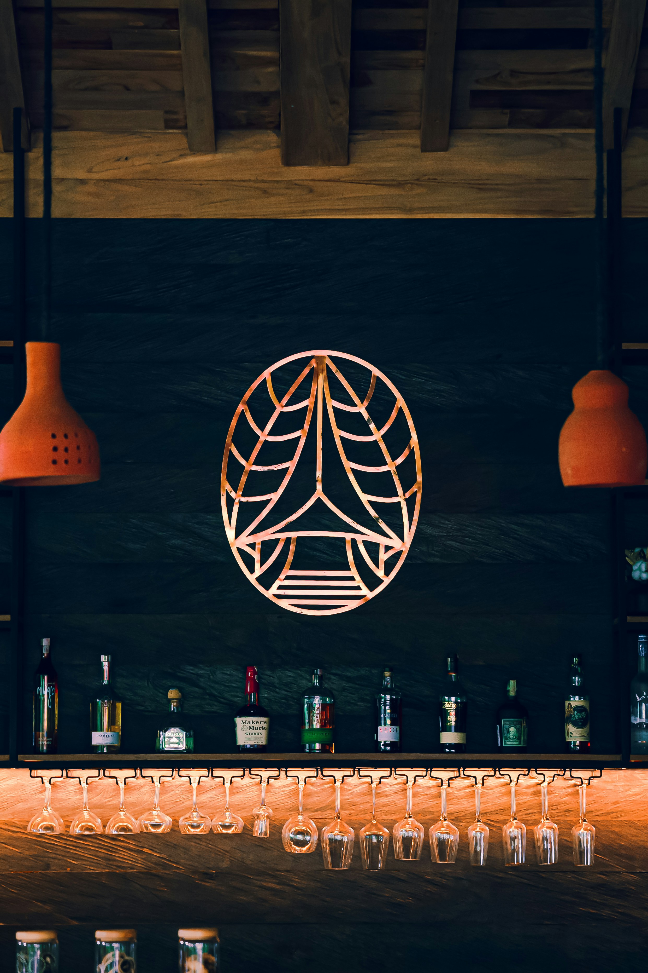 Atmospheric restro bar at night with warm amber lighting, cocktail glasses, and vintage Portuguese decor