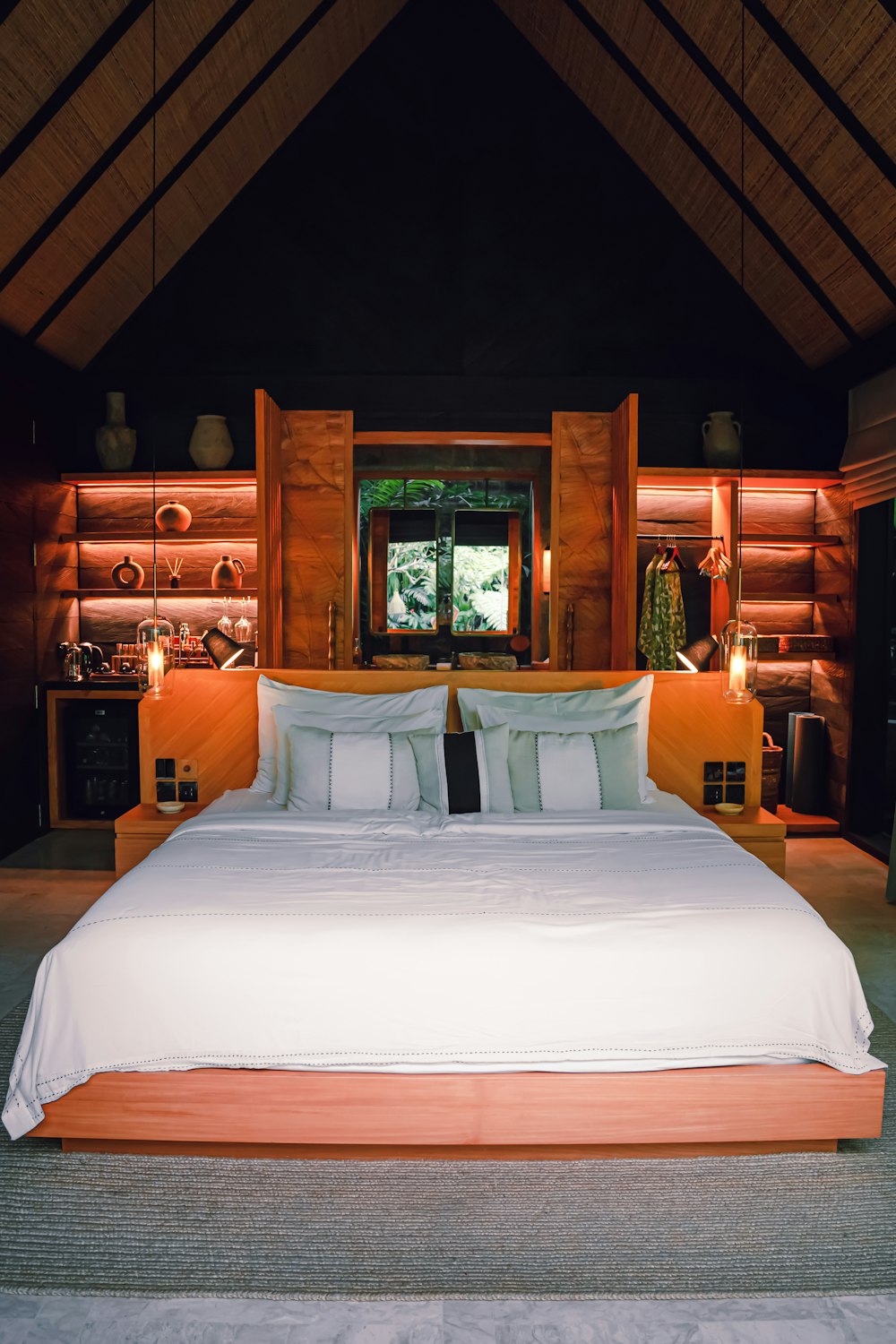 a large bed in a bedroom with a wooden ceiling