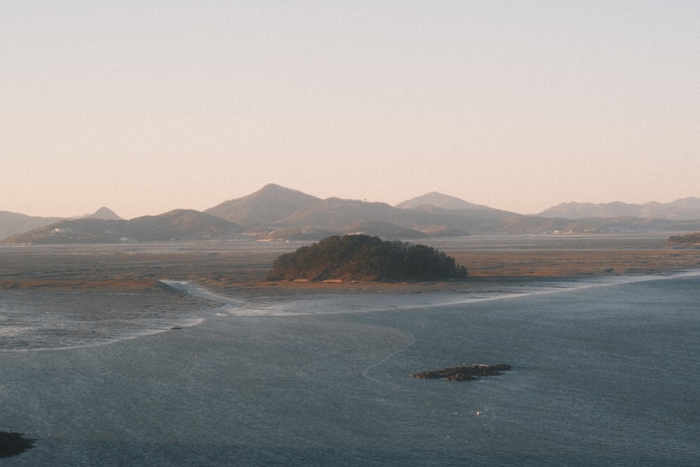 a body of water with mountains in the background