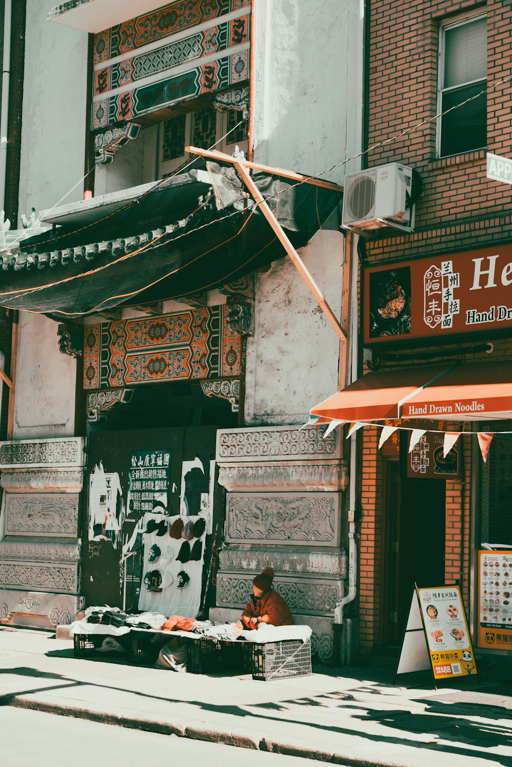 a person sitting on a bench in front of a building