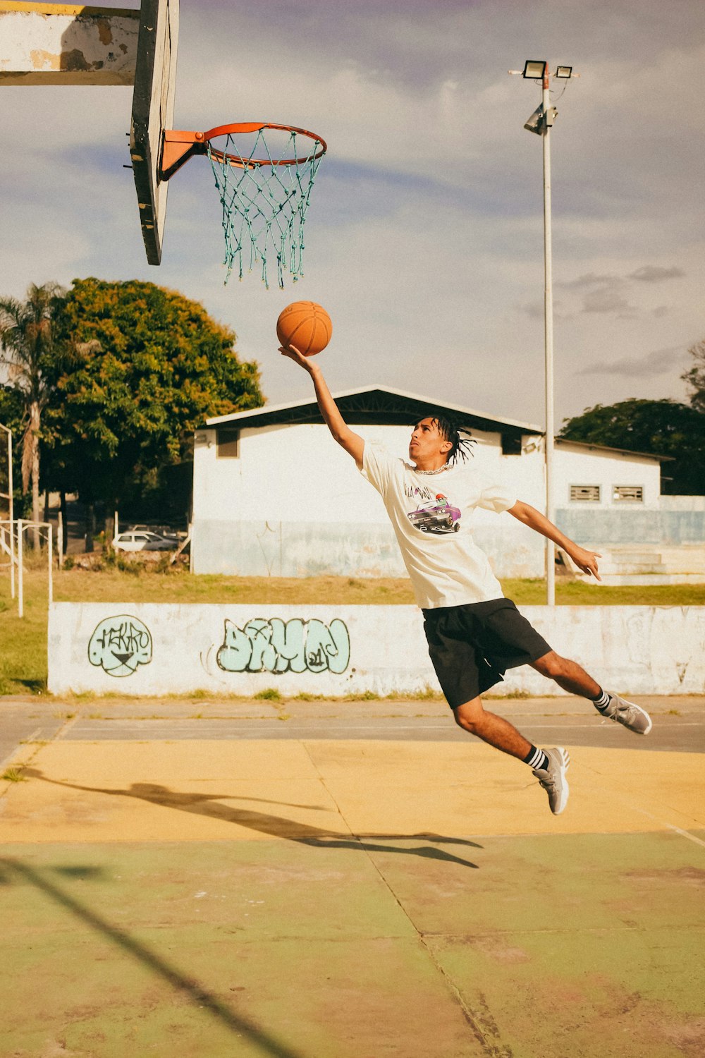 a young man jumping up to dunk a basketball