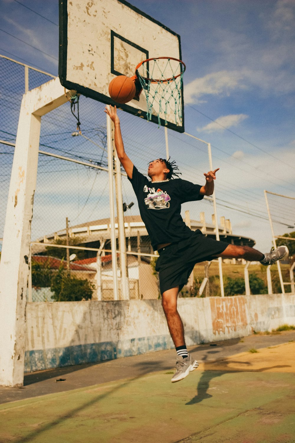 a man jumping up into the air to dunk a basketball