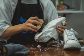 a person with a pair of shoes on a table