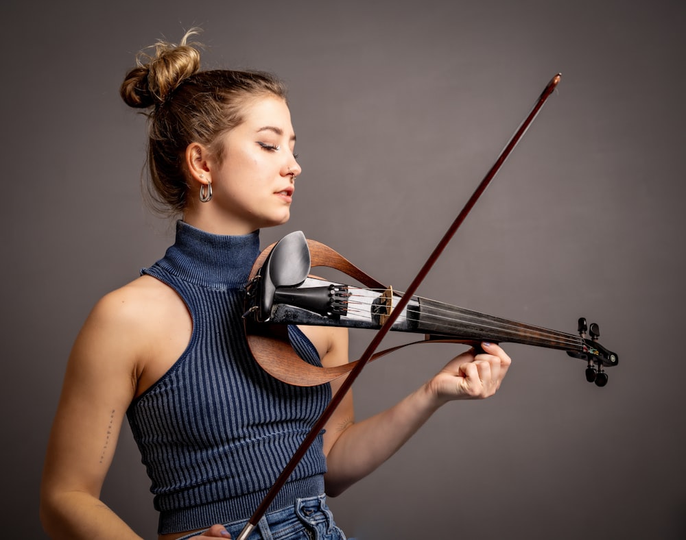 a woman holding a violin in her right hand