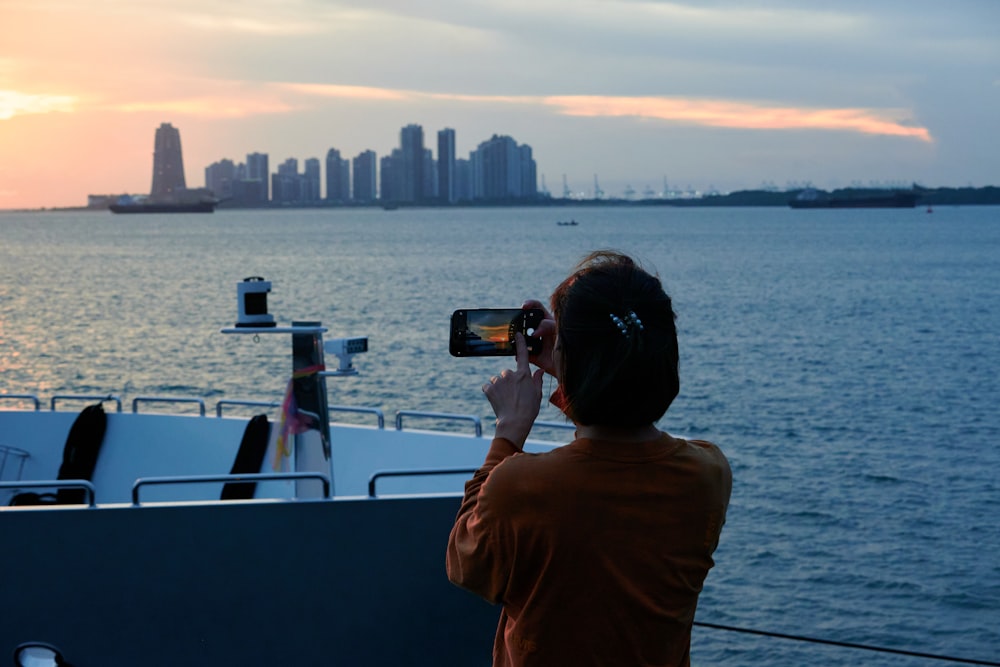 a person taking a picture of a boat in the water