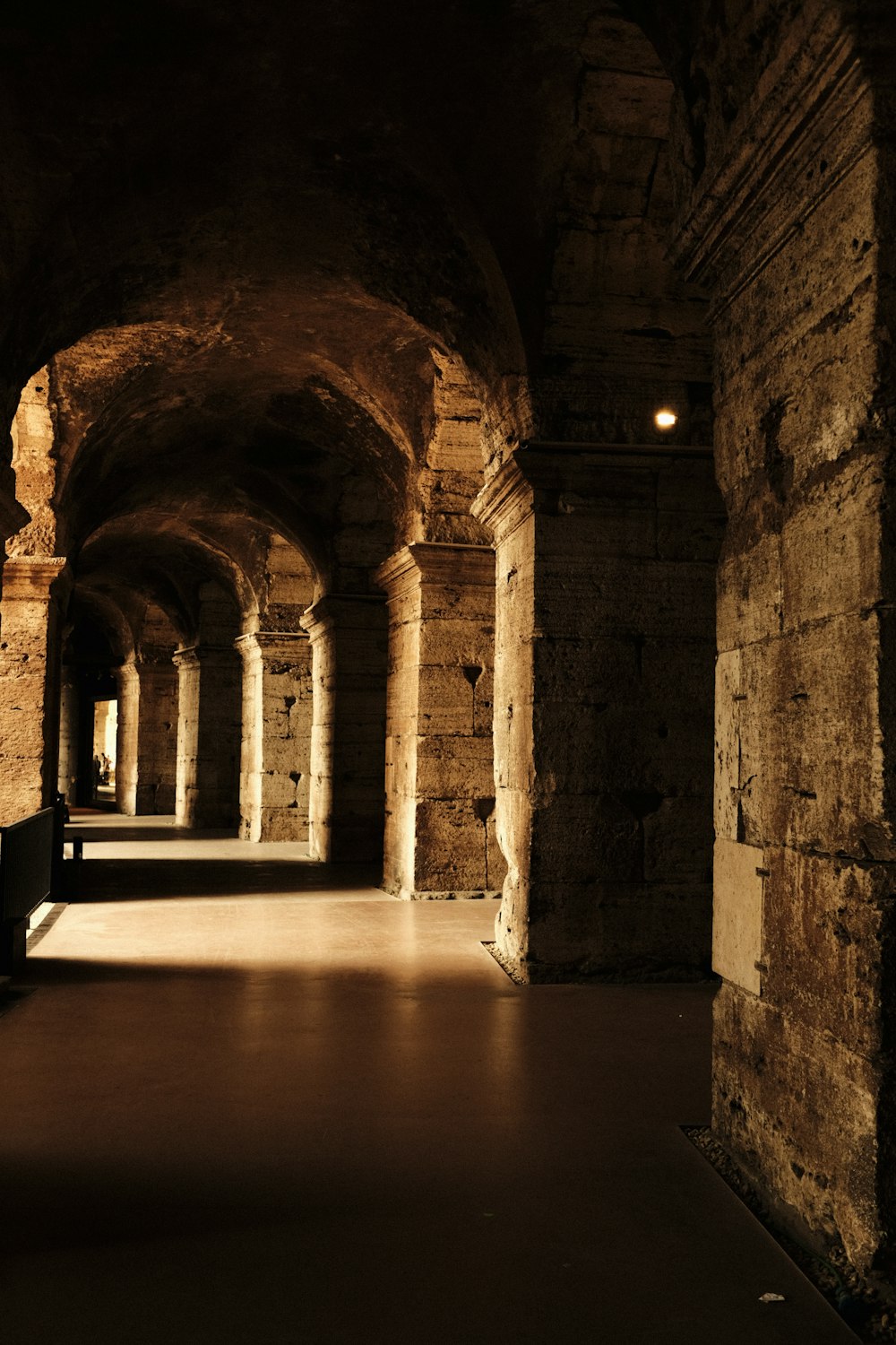 a long tunnel with a bench in the middle of it