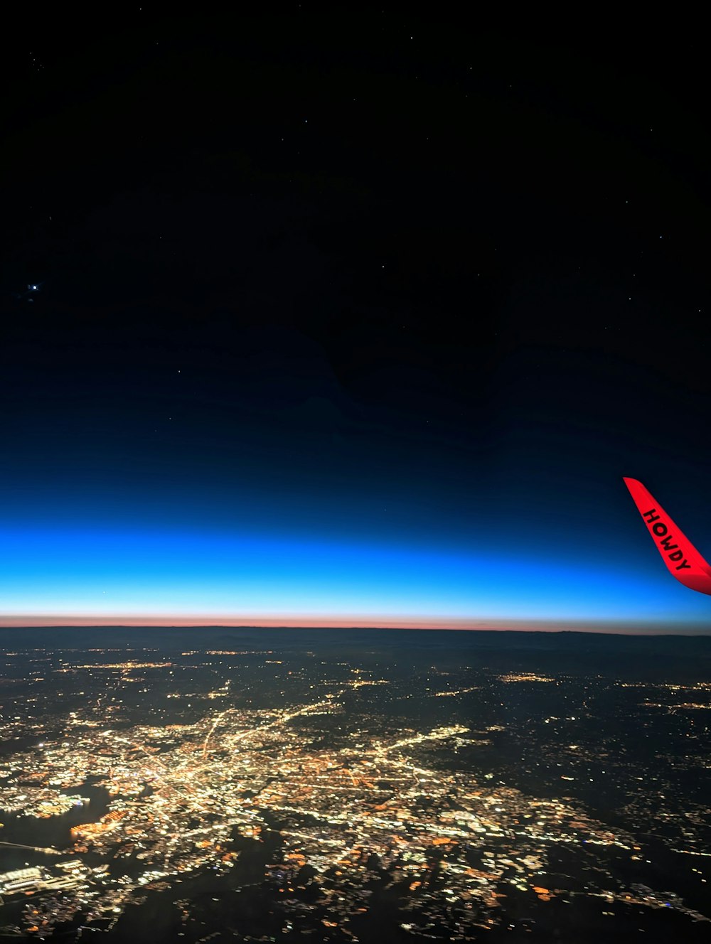 a view of a city at night from an airplane