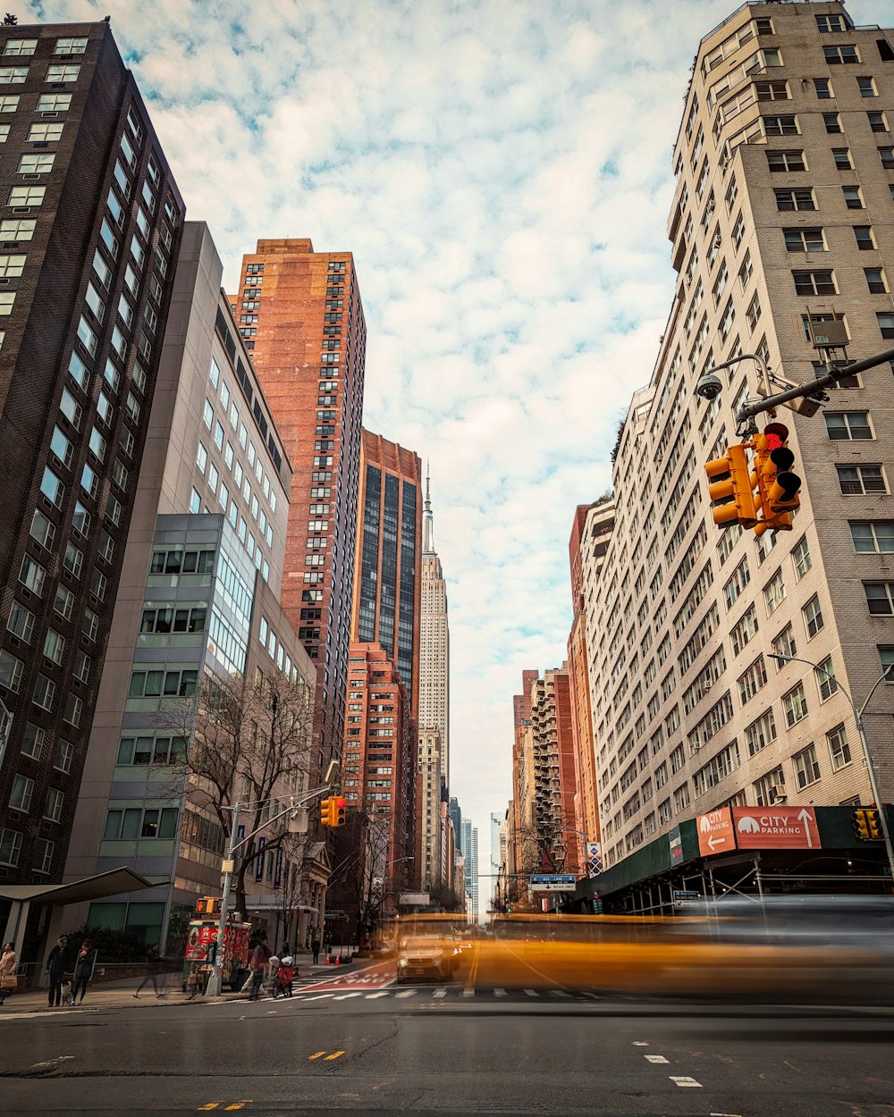 a city street with tall buildings and a traffic light