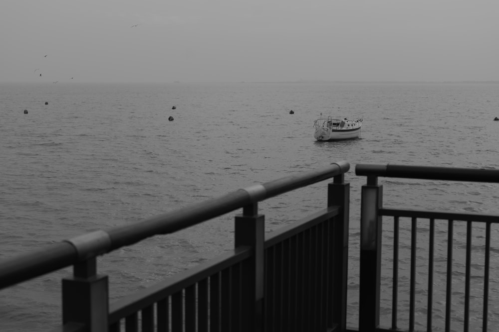 a boat is out in the ocean on a foggy day