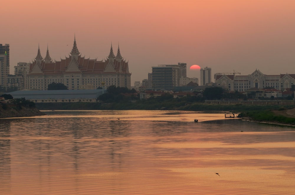 the sun is setting over a large city