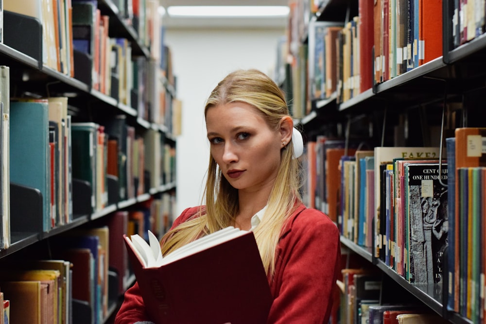 a woman reading a book in a library