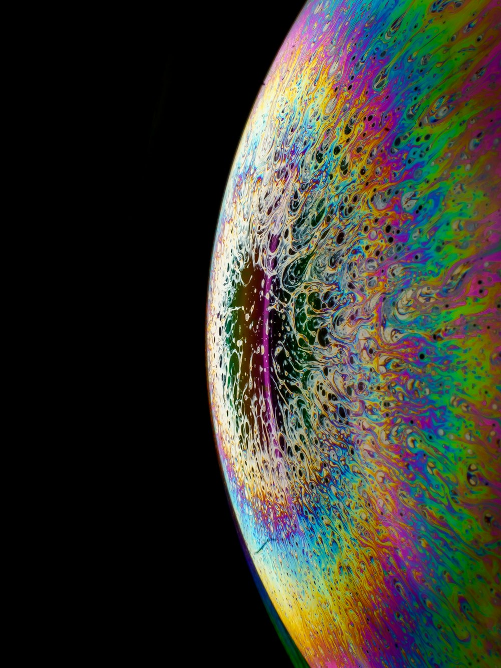 a close up of a colorful object with a black background